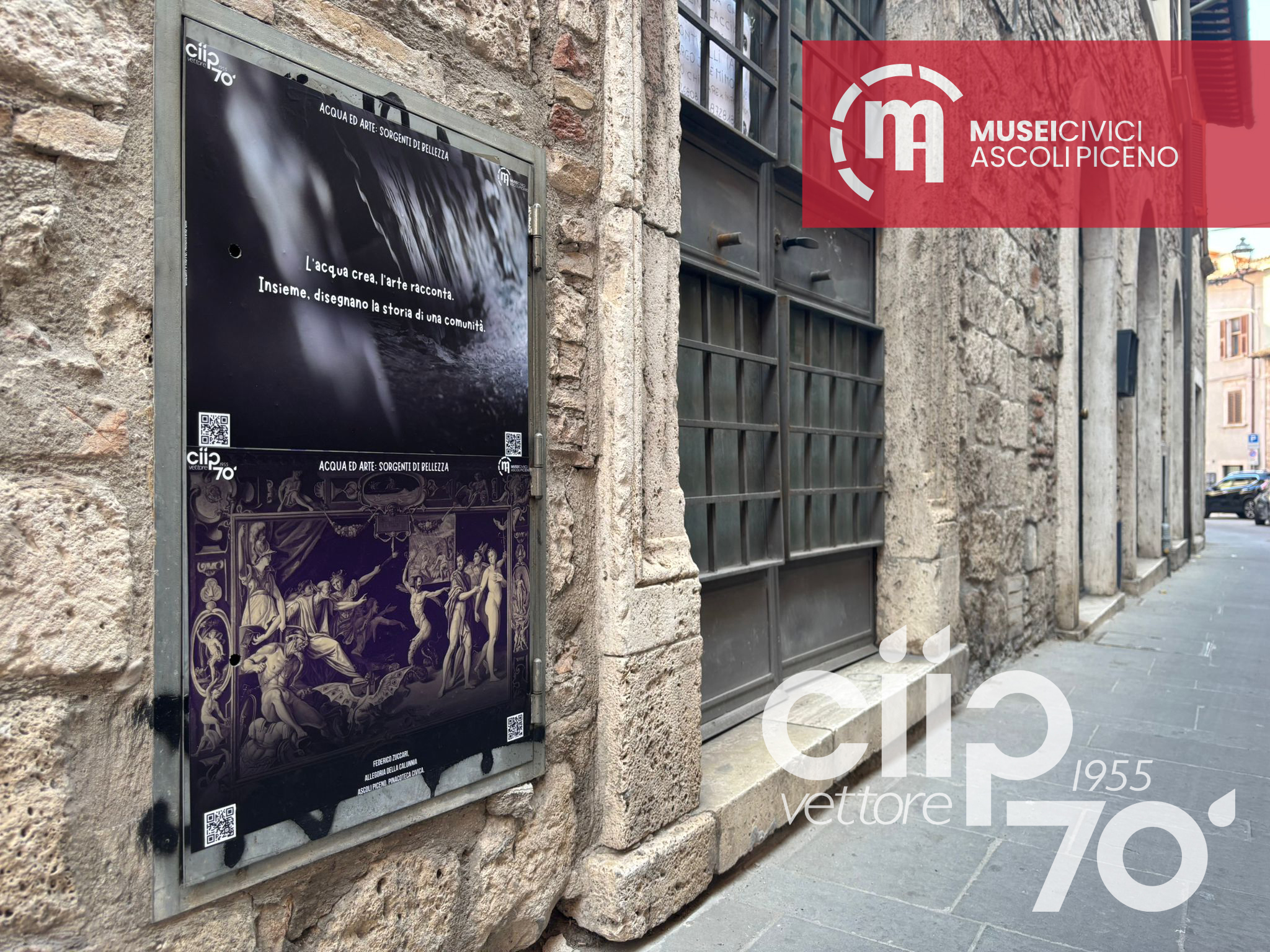 Foto di una via cittadina con lo sportello dei contatori CIIP decorato con stampe di fotografie artistiche e opere d’arte